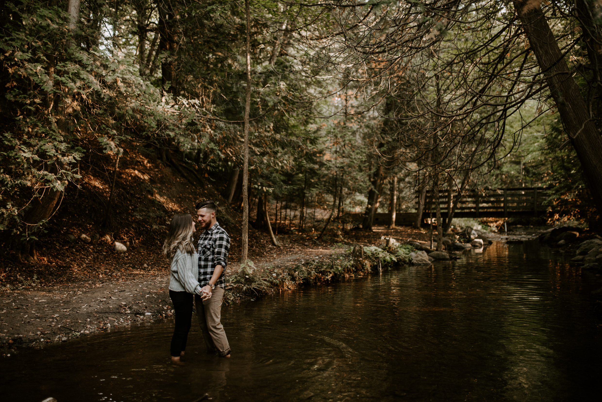 Muskoka Engagement Session - holding hands in the river