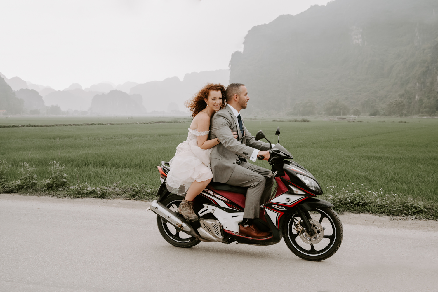 bride and groom ride motorbike in Vietnam 