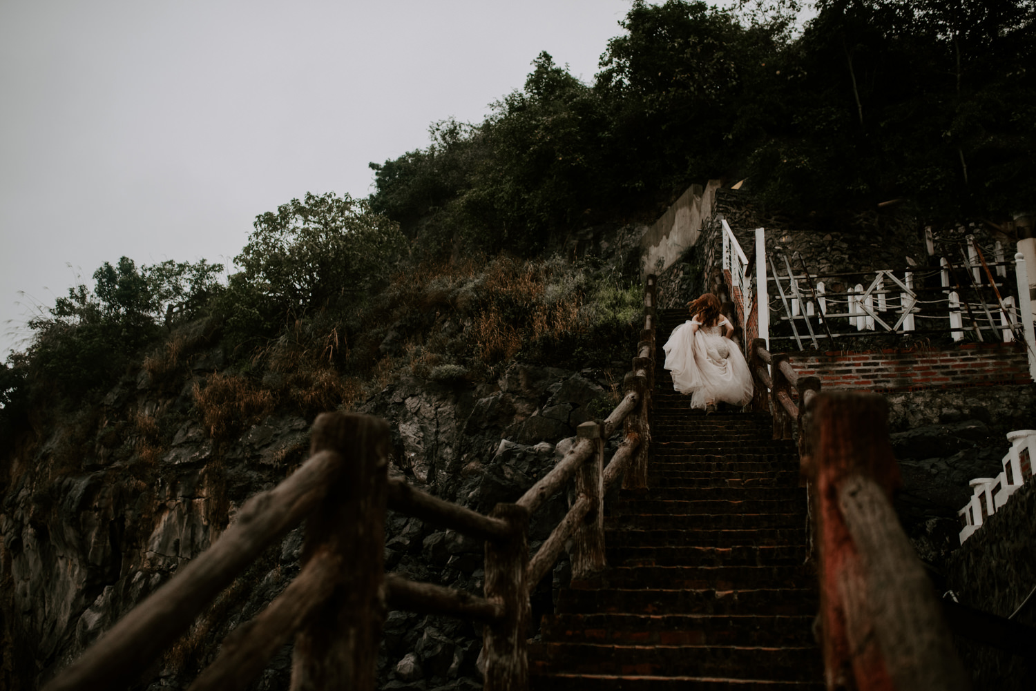 bride walking up stairs during elopement in vietnam